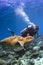Scuba diver swimming with turtle