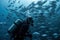 a scuba diver swims among a shoal of fishes Generative AI
