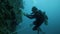 Scuba diver taking photos of lionfish