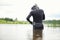 A scuba diver in a wet suit prepares