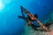 Scuba divers explores propeller of sunken shipwreck in cortez sea