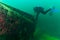 SCUBA divers exploring a mysterious sunken helicopter