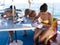 Scuba diving students studying onboard dive boat