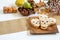 Scull cookie on the wood plate, panelles de piÃ±ones, chestnuts and pumpkins on the table. Preparation for Halloween, life style