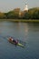 A scull team glides past Harvard University