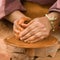 Sculpting clay; close up of womanÂ´s hands working on a potters wheel