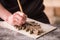 The sculptor creates a bas-relief. Plaster workshop. Close up. Selective focus