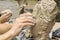 Sculptor creates a bust and puts his hands clay on the skeleton of the sculpture.