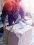 Sculptor gem-worker lifts a crane a piece of marble.