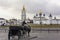 Sculptural composition with a carriage pulled by a horse on the background of the Tobolsk Kremlin. Russia