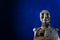 Sculpture of the android robot on a dark blue background