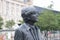 Sculpture of the Beatles on Pier Head, Liverpool, England, in rainy weather. Detail: Portrait of John Lennon