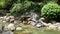 Sculpture of a boy on the rocks by the water