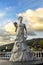 Sculpture of bride girl in dress with bouquet of bride flowers