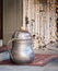 Sculpture of bronze teapot as entrace decoration in Bergamo town, Italy