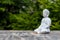 Sculpture of Buddha become enlightened on green background. Yoga and meditation concept