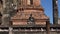 A sculpture of a Buddha on the ruins of the ancient Buddhist temple