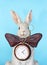 Sculpture ceramic gray hare with a clock for a home interior