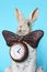 Sculpture ceramic gray hare with a clock for a home interior