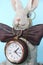 Sculpture ceramic gray hare with a clock for a home interior