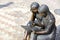 Sculpture `Couple reading on a bench` in the mountain park named after P.P. Bazhova on a summer day