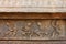 Sculpture of dancing women with sticks on temple wall