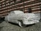 Sculpture depicting a Cadillac car made of white Carrara marble displayed in a town square