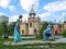 Sculpture of the fairy tale `Cinderella and the Prince` on the background of a castle in the children`s park `Kazka` in Sumy