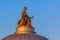 Sculpture of the goddess Minerva on top of the dome of the Academy of Arts in Saint Petersburg, Russia at sunset