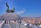 Sculpture Goddess Victoria riding on quadriga ,against the scenic panorama of the city of Rome . Roof of Altar of the Fatherland