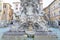 sculpture of a human head gushing liquid from the mouth of a water fountain in front of the pantheon in the Italian city of Rome.