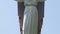 Sculpture of Jesus Christ with outstretched arms against sky, vertical panorama