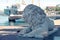 Sculpture of a lion on the Count`s pier on the blurred background of the ship