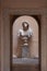 Sculpture of a male bust in a small courtyard