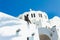 Sculpture of a man sitting on the roof of the Orthodox Metropolitan Cathedral of Ypapanti in Fira village