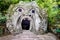 Sculpture Ogre Mouth, at the famous Parco dei Mostri, also called Sacro Bosco or Giardini di Bomarzo. Monsters park. Lazio, Italy