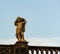 A sculpture placed on a balcony railing in a public park in Dresden, Germany
