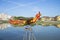 Sculpture of a rooster, flying over the Thu Bon river. Hoi An, Vietnam