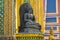 Sculpture seated Buddha near the temple wall