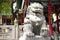 Sculpture stone lion guardian at entrance of Wong Tai Sin Temple at Kowloon in Hong Kong, China