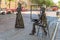 Sculpture `Street painter and a lady with an umbrella`