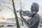 Sculpture with violinist in winter day with frost