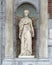 Sculpture of a woman in a Nave between two columns, beside the entrance to the Rijksmuseum, Amsterdam