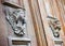 Sculpture of a wooden angel on a old italian door Italy - more than a hundred years old