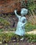 Sculpture of young girl waving her right handl in a garden outside a mansion in Highland Park, Texas