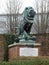 Sculptured group of a lion with its paws holding down an eagle on brick plinth