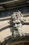 The sculptured head of an old man decorates the facade of a building (France)