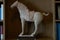 Sculptured rock horse statue on Book shelf for decoration in room
