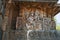 Sculptures on the facade, west side walls. Shiva-Parvati. Hoysaleshwara temple, Halebidu, Karnataka, India.