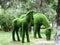 Sculptures of green horses from artificial grass